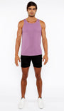 Man wearing a purple tank top and black shorts on a white background