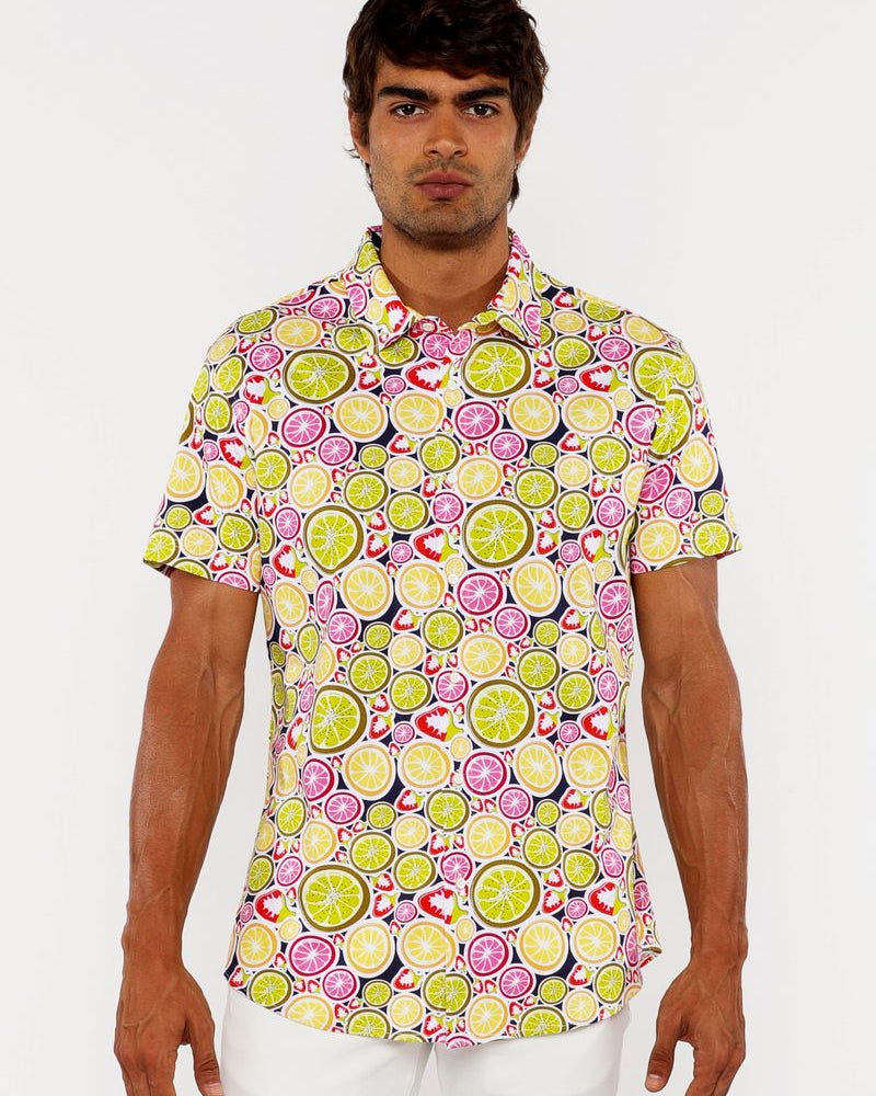Man wearing a colorful patterned shirt with a white background