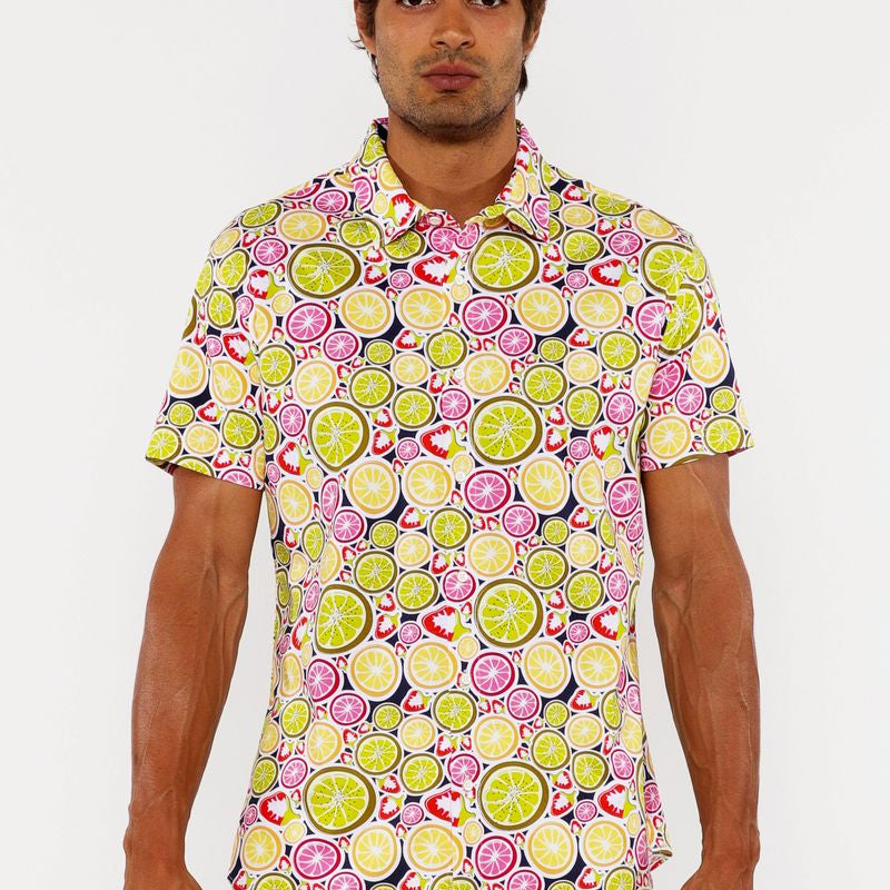 Man wearing a colorful patterned shirt with a white background