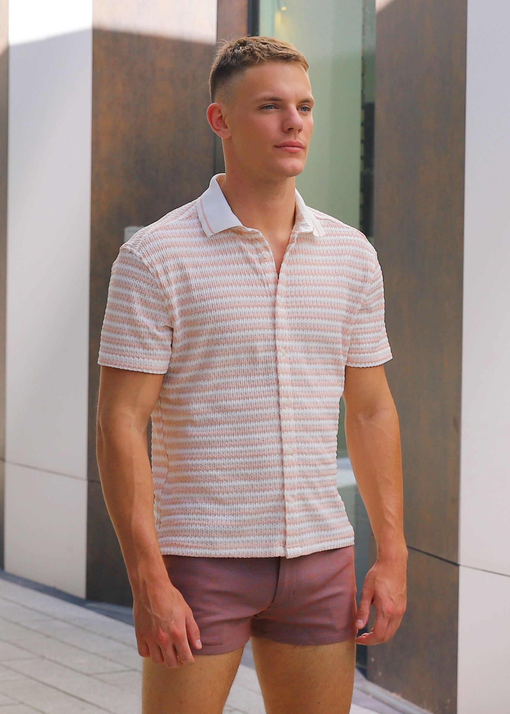 Man standing outdoors near modern architectural elements