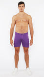 Man wearing purple shorts on a white background