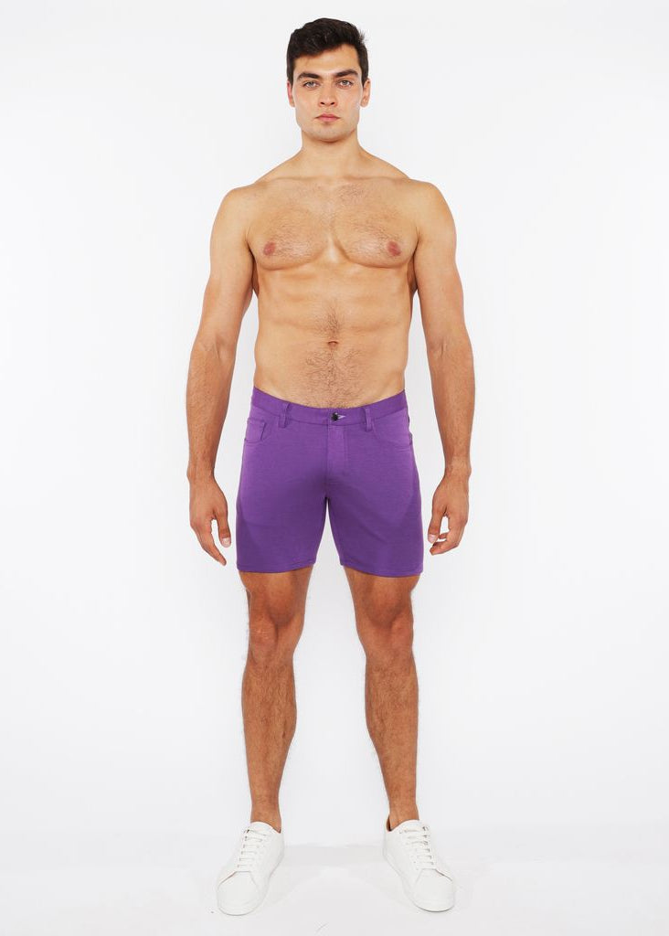 Man wearing purple shorts on a white background
