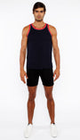 Man wearing a black tank top with red trim and black shorts on a white background