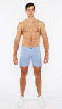Man wearing light blue shorts on a white background