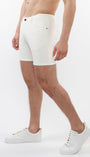 A model wearing white stretch knit shorts with a 5-inch inseam and a slim fit through the thighs and seat.