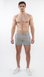 A model wearing ecru and black herringbone patterned chino shorts with zip pockets.