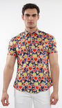 A male model wearing a short-sleeved printed cotton knit jersey shirt with a sapphire blue and persimmon hearts pattern and a contrast placket detail.