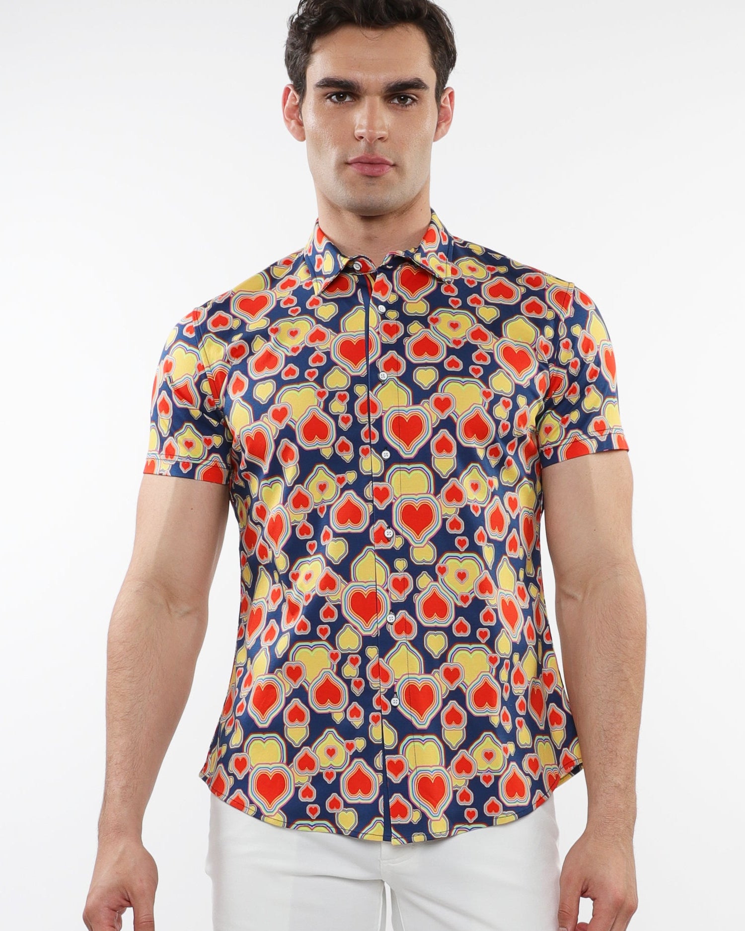 A male model wearing a short-sleeved printed cotton knit jersey shirt with a sapphire blue and persimmon hearts pattern and a contrast placket detail.