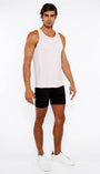 Man wearing a white tank top and black shorts on a white background