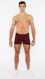 Man wearing maroon underwear on a white background