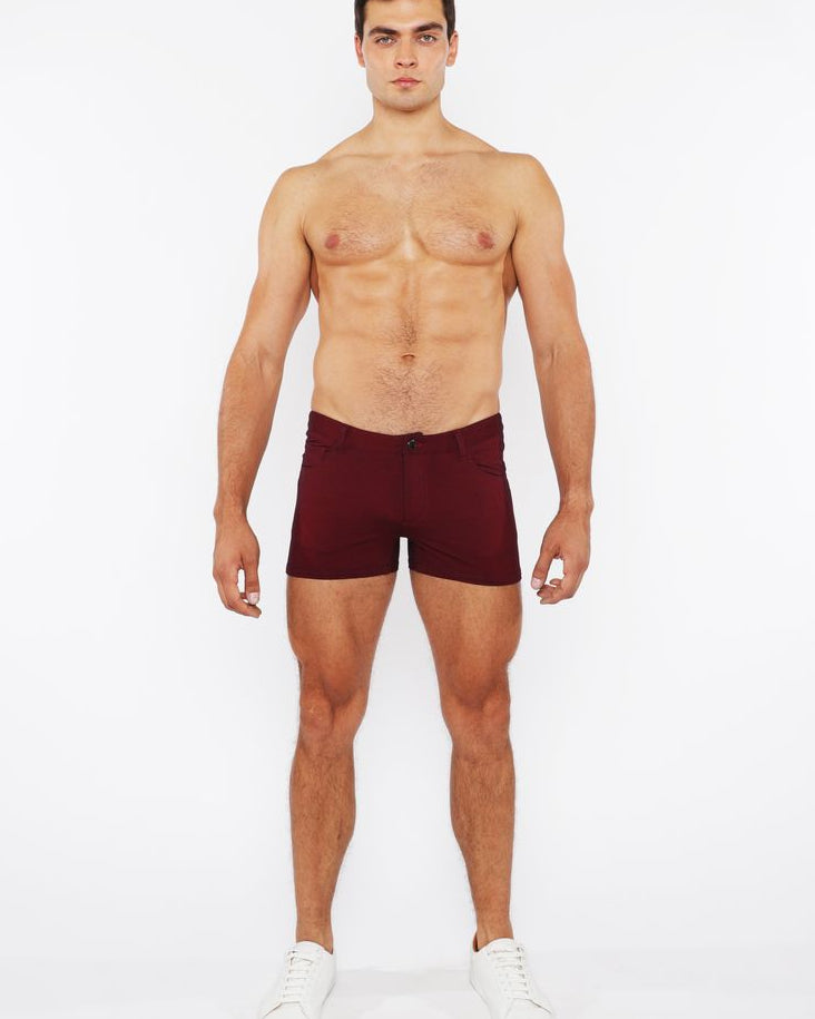 Man wearing maroon underwear on a white background