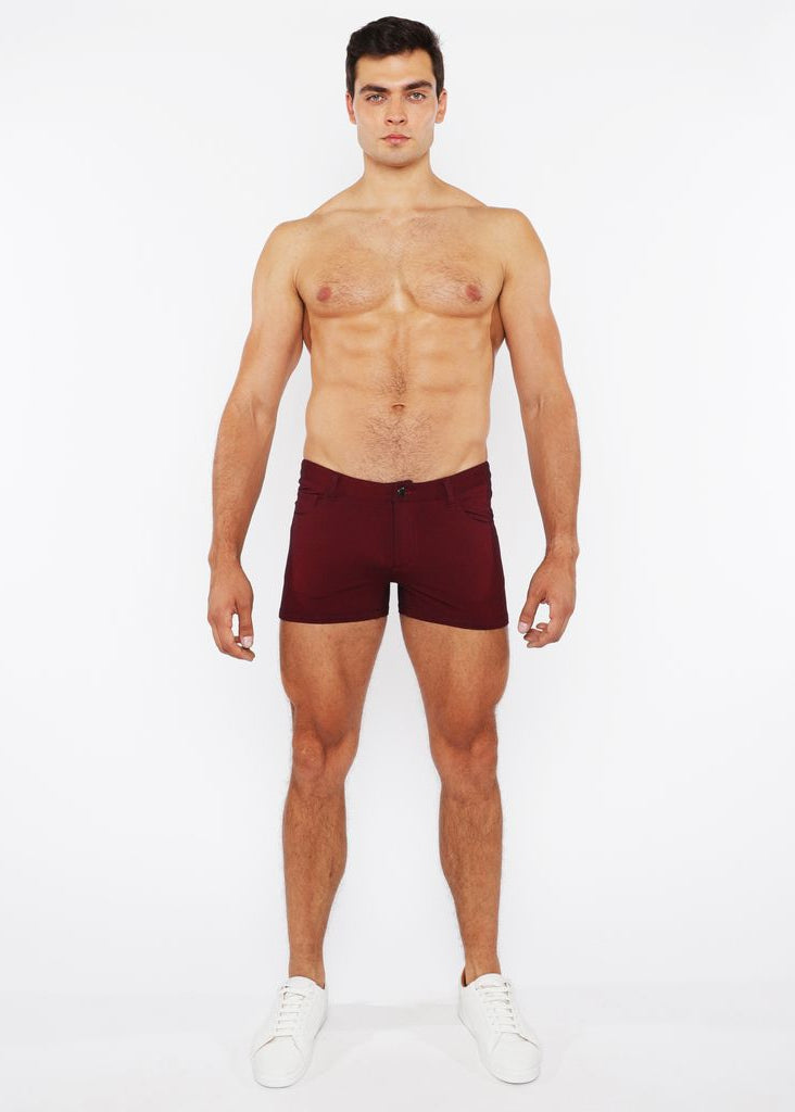 Man wearing maroon underwear on a white background