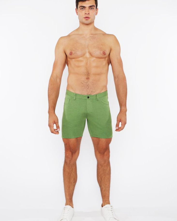Man wearing green shorts on a white background