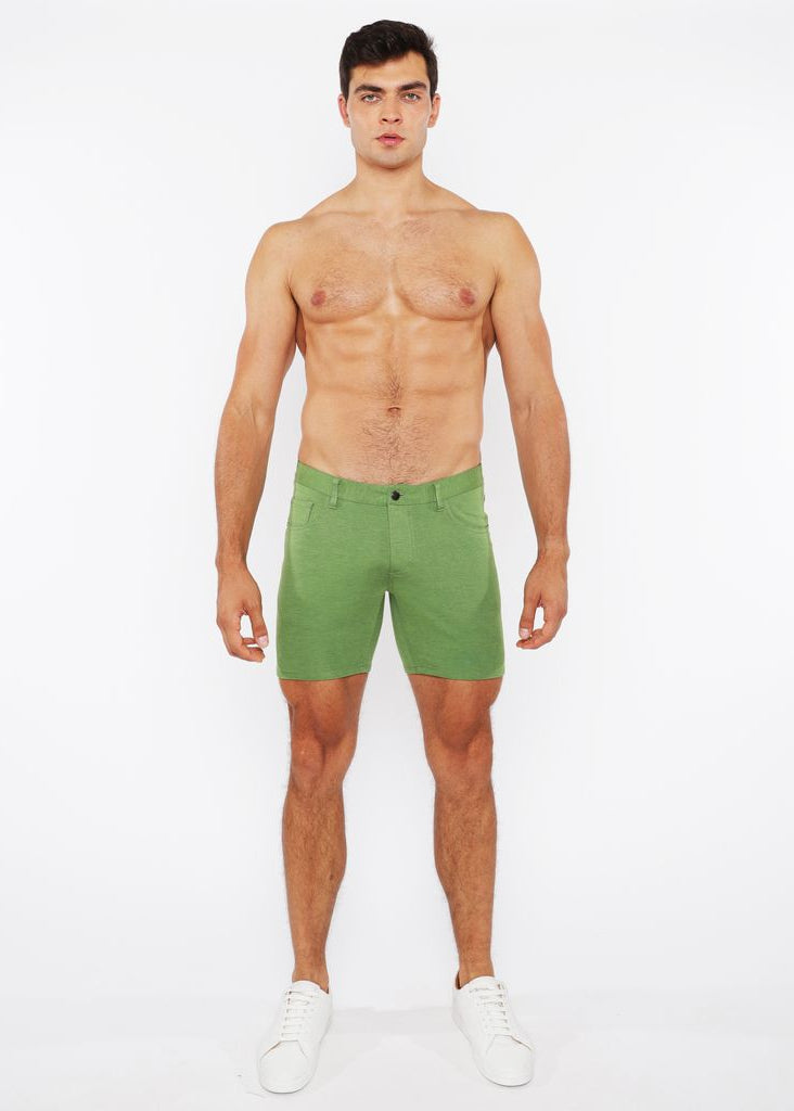 Man wearing green shorts on a white background