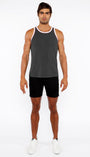 Man wearing a gray tank top and black shorts on a white background