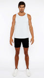 Man wearing a white tank top and black shorts on a white background
