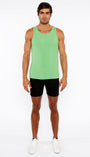 Man wearing a green tank top and black shorts on a white background
