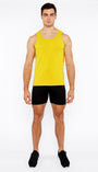 Man wearing a yellow tank top and black shorts on a white background