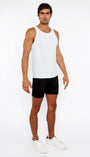 Man wearing a white tank top and black shorts on a white background