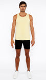 Man wearing a yellow tank top and black shorts on a white background