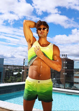 Man in colorful swimwear posing by a pool with a cityscape in the background