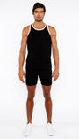 Man wearing a black tank top and shorts on a white background