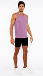 Man wearing a purple tank top and black shorts on a white background